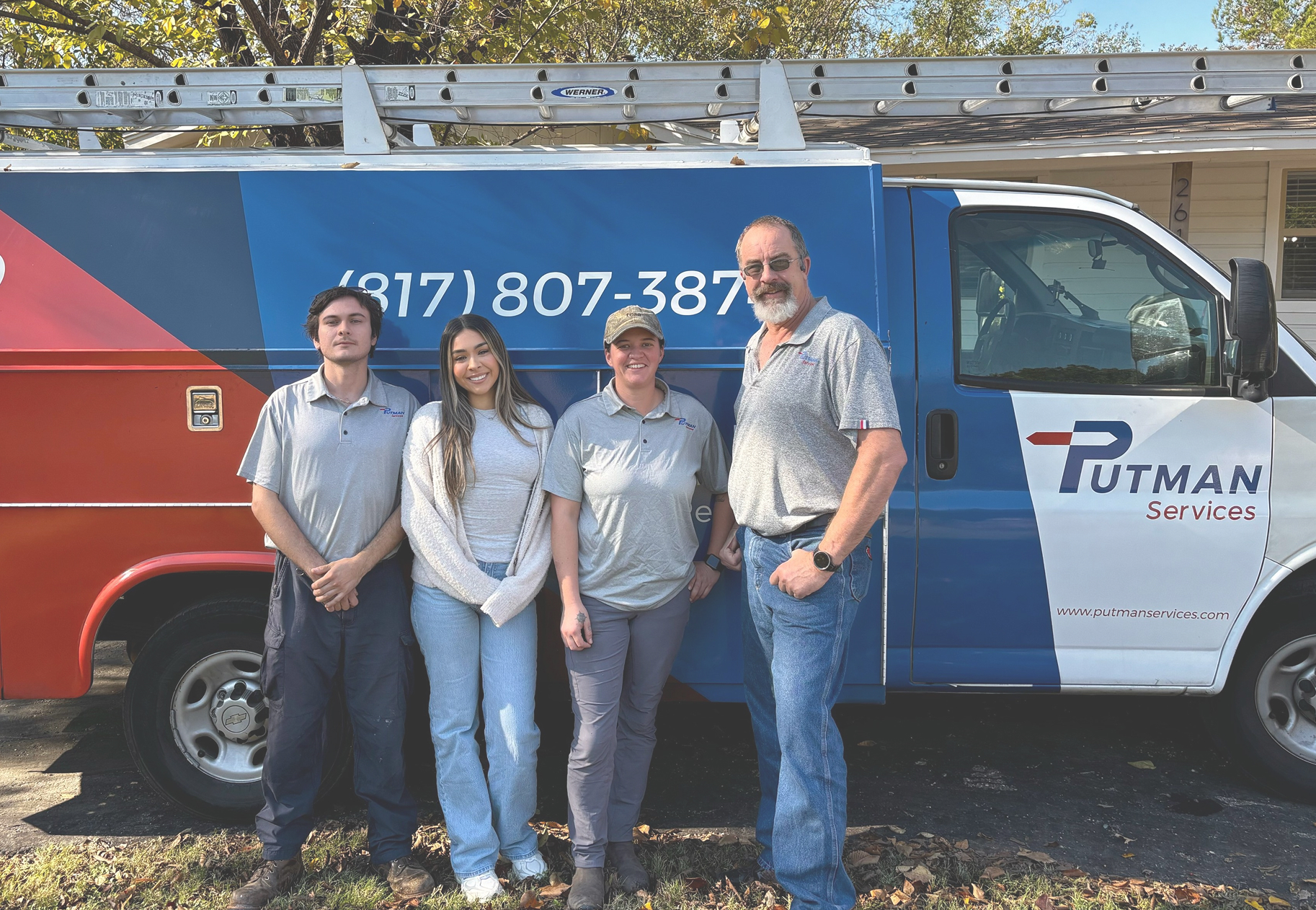 Putman Services' team in front of HVAC service vehicle.